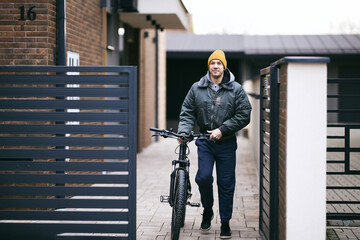 Mature Man Getting Out from the Door of his House