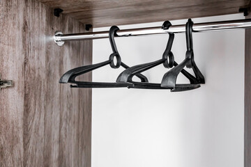 plastic empty clothes hangers hanging in the closet