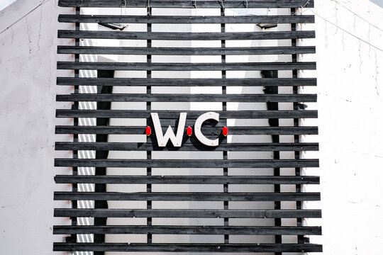 wc inscription on the wooden grate above the toilet entrance