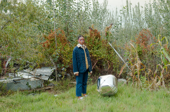 Young African woman posing with balloon