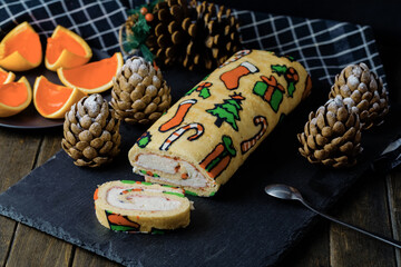 Christmas desserts: roll with traditional Christmas patterns, chocolate cones cakes and orange...