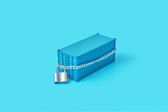 Miniature blue cargo with ribbed surface tied with metal chain