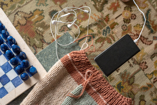 Knolling still with in-progress sweater and phone charging