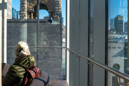 Senior woman sitting by the window in Montreal