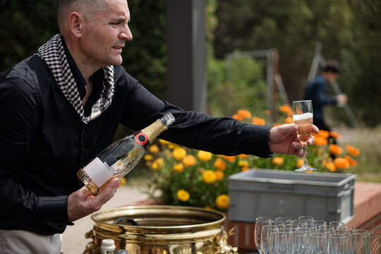 Waiter serving glass of champagne 
