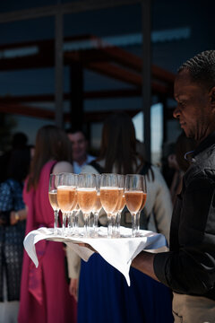 Waiter serving glasses of champagne 