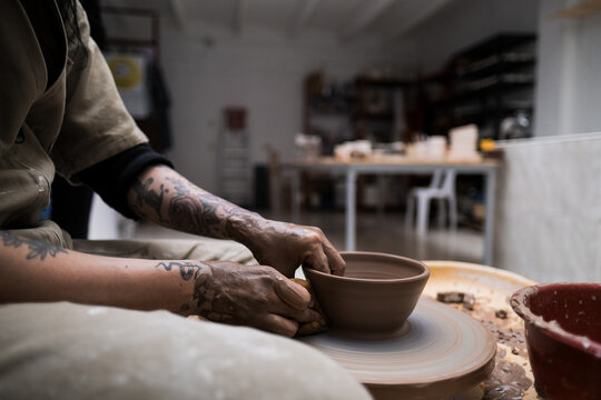 ceramist making pot on clay wheel
