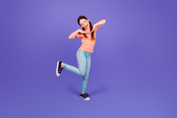 Full body photo of cute little girl dance have fun frame beauty dressed stylish red clothes isolated on violet color background