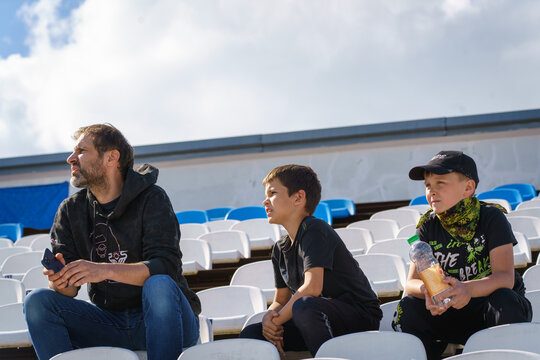 father and sons sports fans
