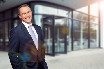 Portrait of attractive serious man in suit walking