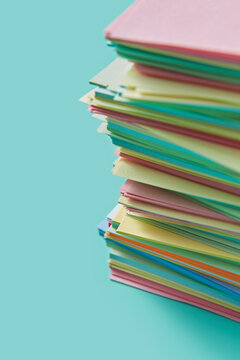 Stack of colourful post it notes arranged in chaotic tower