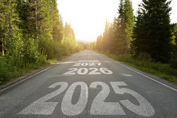 New year 2025 or straight forward concept. Text 2025, 2026, 2027, 2028 written on the road in the...