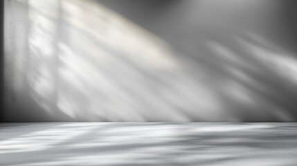 A serene gray background with soft light and shadows, perfect for showcasing products or creative designs.