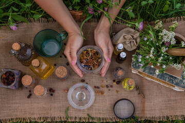 woman and herbal tinctures, tea, medicinal herbs.