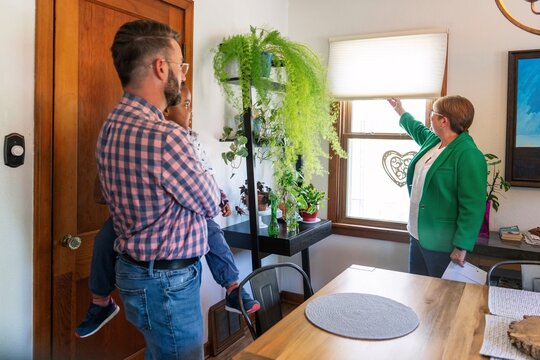 Real Estate Agent Showing Home Features to Family