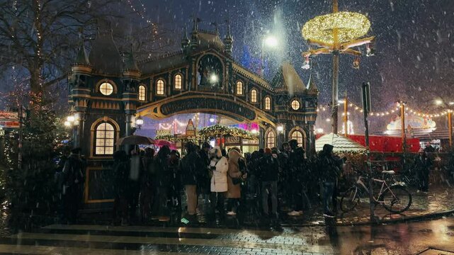 Cologne, Germany - Jan 02, 2024: Cologne Christmas market night scene with havy snow fall and crowd of people at night