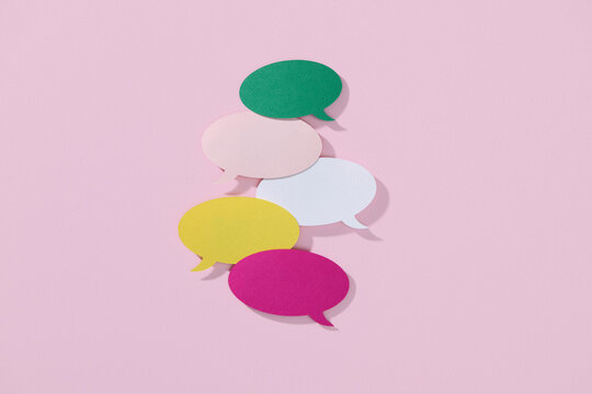 Colorful Paper Speech Bubbles on Pink Background