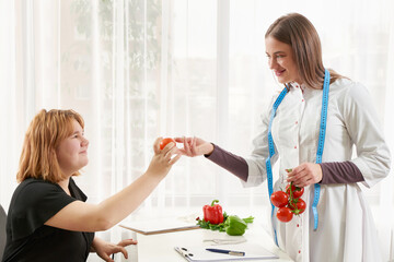 Young girl visiting nutritionist to lose weight with the help of diet program