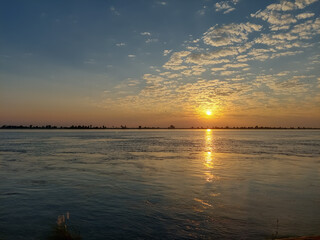 Sunset scenery of Padma river with white cloud and blue sky