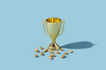Fragments of gold laying close to metal winner goblet
