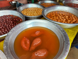 Different types of Homemade sweet in village fair which shape of fish in sugar juice