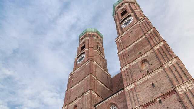 Frauenkirche Church exterior of building in Old Town Square in Munich looking up perspective timelapse. The famous church is a landmark and is considered a symbol of the Bavarian capital city. Germany