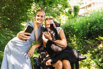 Person with a disability and Assistant taking a selfie 