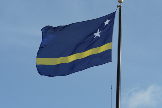 The national flag of Curaçao represents the country of Curaçao as well as the island area within the Netherlands Antilles. Flag is a blue field with a horizontal yellow stripe and two white stars.
