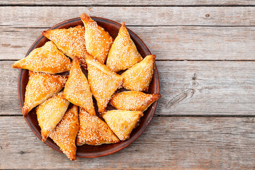 Homemade triangle puff pastry with meat on rustic background . Samosa