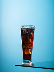 Whiskey on the rocks on blue background