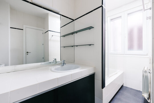 A modern, white bathroom