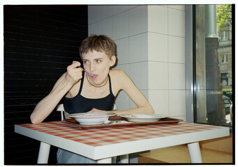 the girl leaned over a plate of soup