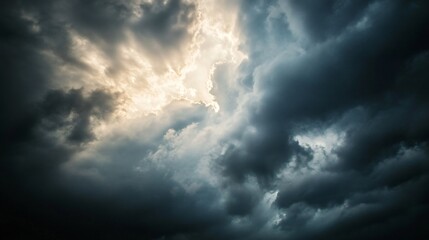 Obraz premium Dark clouds with the sun breaking through, stormy weather, dramatic lighting