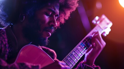 Obraz premium An Afro man playing an acoustic guitar