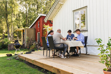 Family Enjoying Summer Lunch in backyard