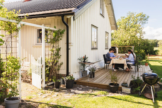 Family Enjoying Summer Lunch in backyard