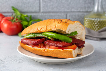 Sausage with bread on a wooden background. Turkish name; Sucuk ekmek - ekmek arası sucuk