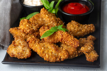 Crispy home made deep fried chicken strips . Breaded with cornflakes chicken breast fillets