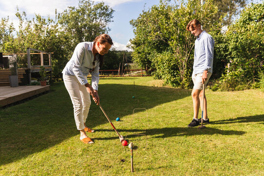 Mother and Teenage Son Playing Summer Games in Backyard
