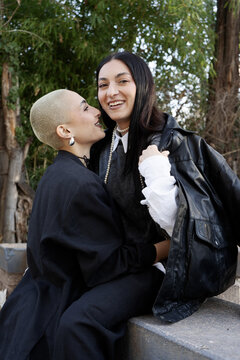 Smiling young couple standing affectionately together outdoors