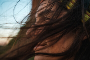 profile of woman with long hair blowing with the wind 