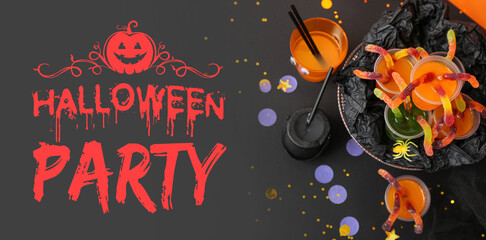 Halloween party composition with punch and gummy worms on black table