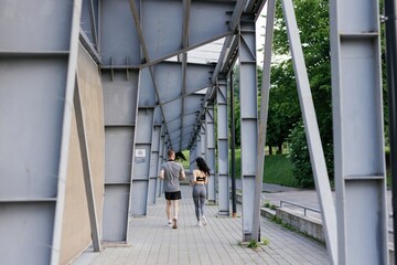 View from afar photo of athletic couple jogging with backs to camera