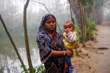South asian young mother holding her son 