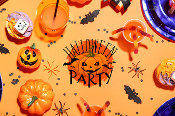 Frame made from Halloween party table setting on orange background