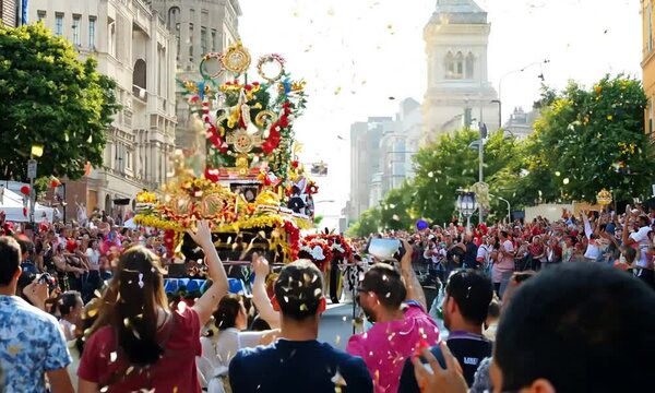 City street with a parade or public event taking place, featuring floats and crowds