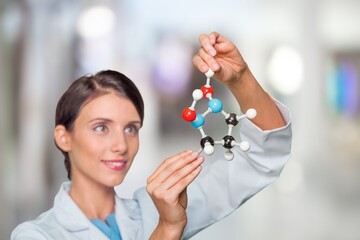 Scientist holding molecular model in laboratory