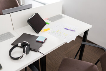 Study desk with tablet, headphones and notes