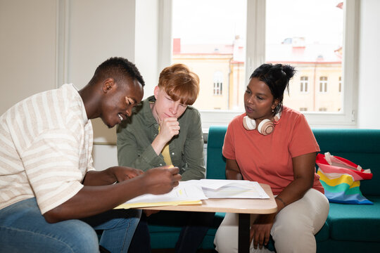 Students preparing for lesson in college corridor