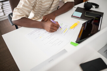 Anonymous student studying at library desk